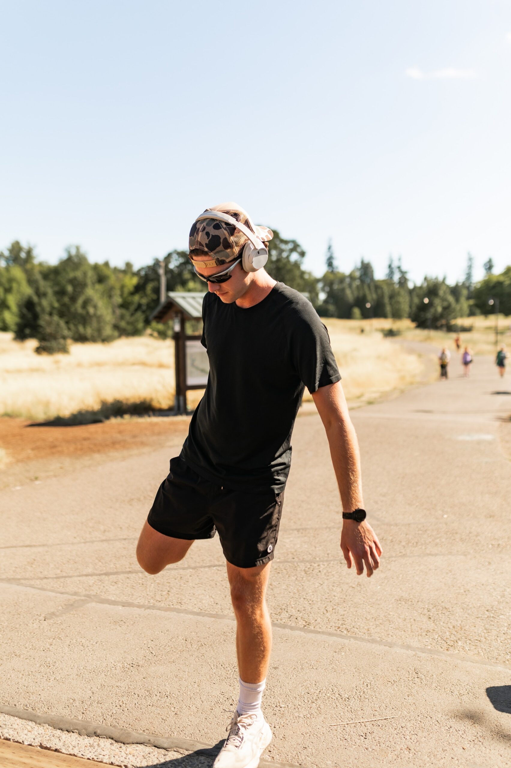Boy stretching before a run in Alton Baker Park