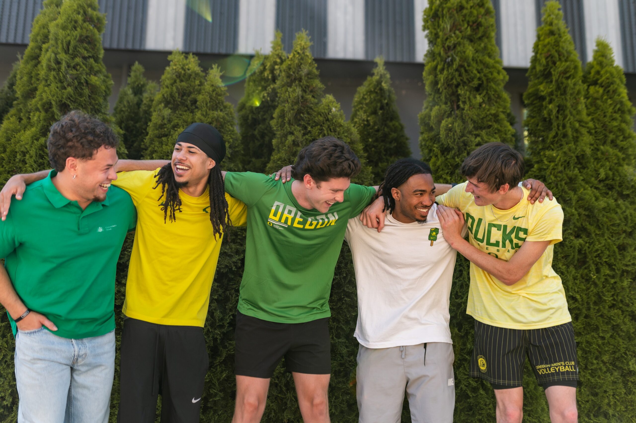 Group of boys in University of Oregon shirts with their arms around each other_s shoulders_