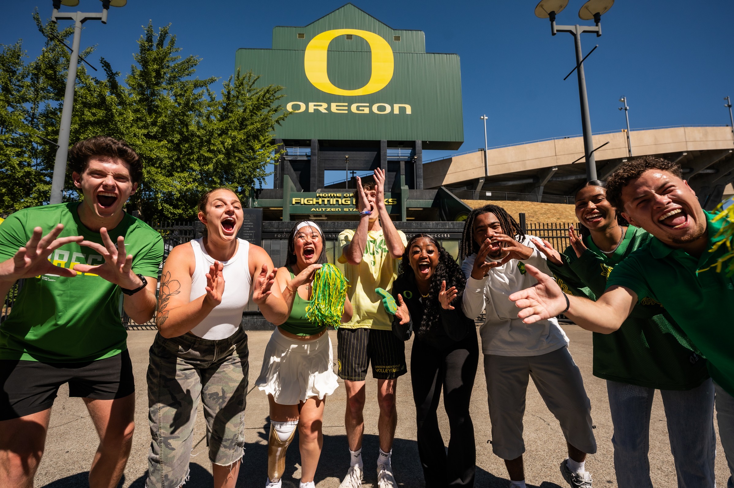 Group of students in their game day gear in front of Autzen Stadium