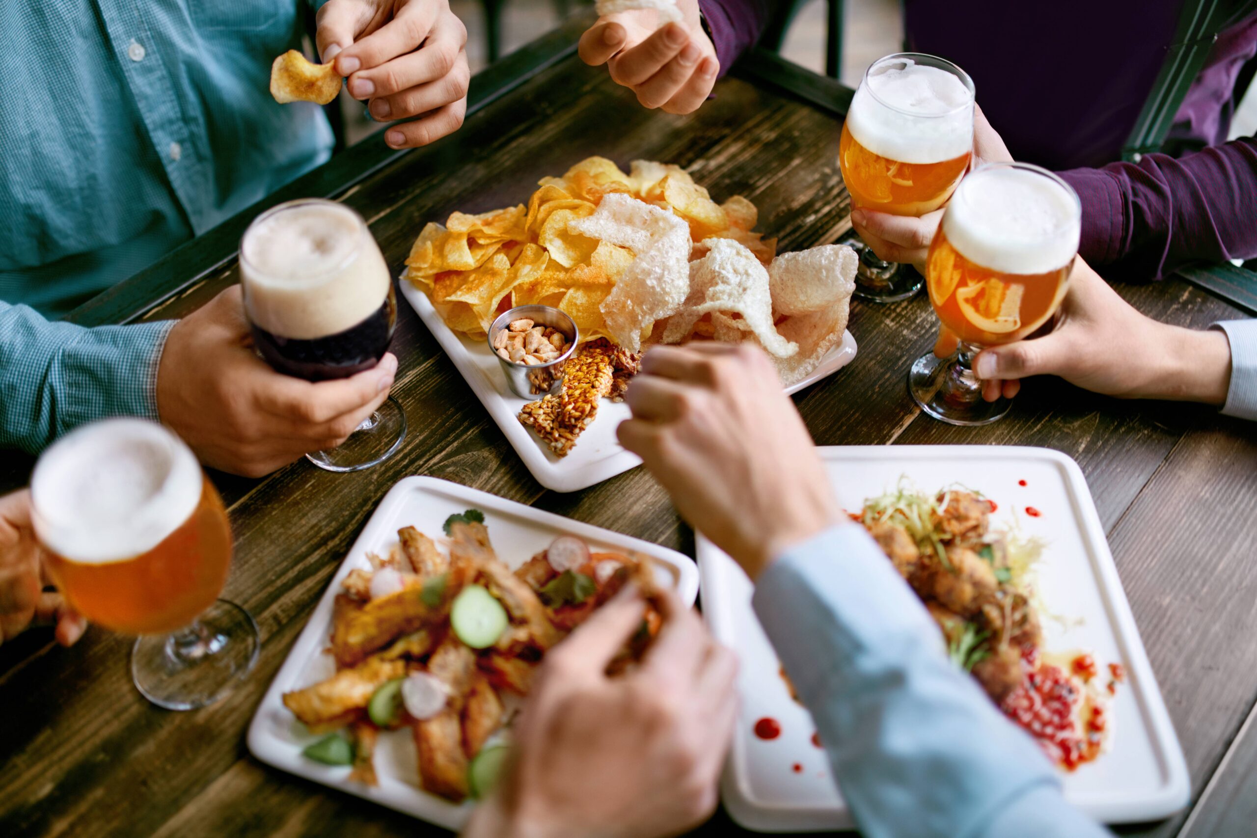 friends sharing pub food and beer scaled