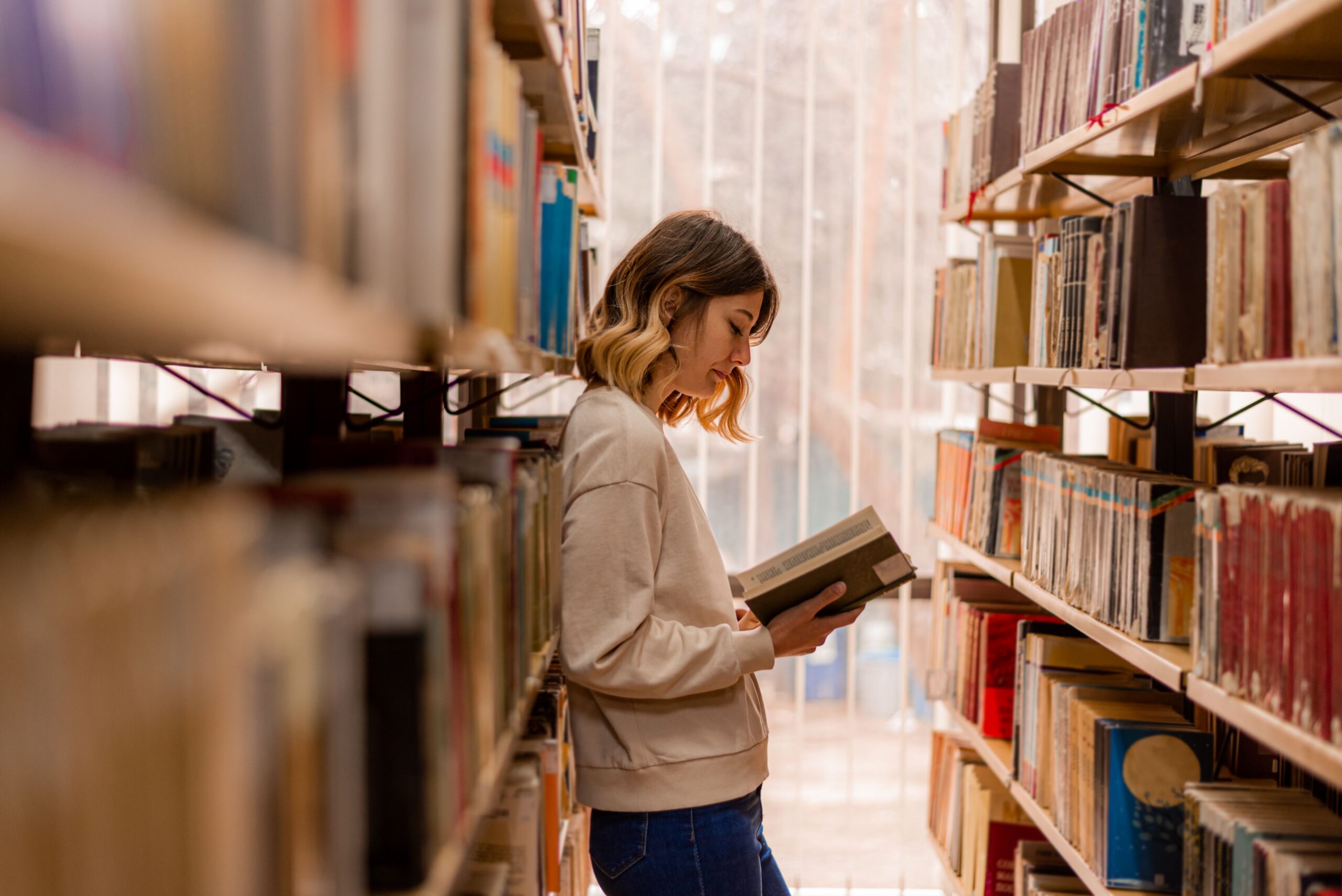 Woman reading a book in the library