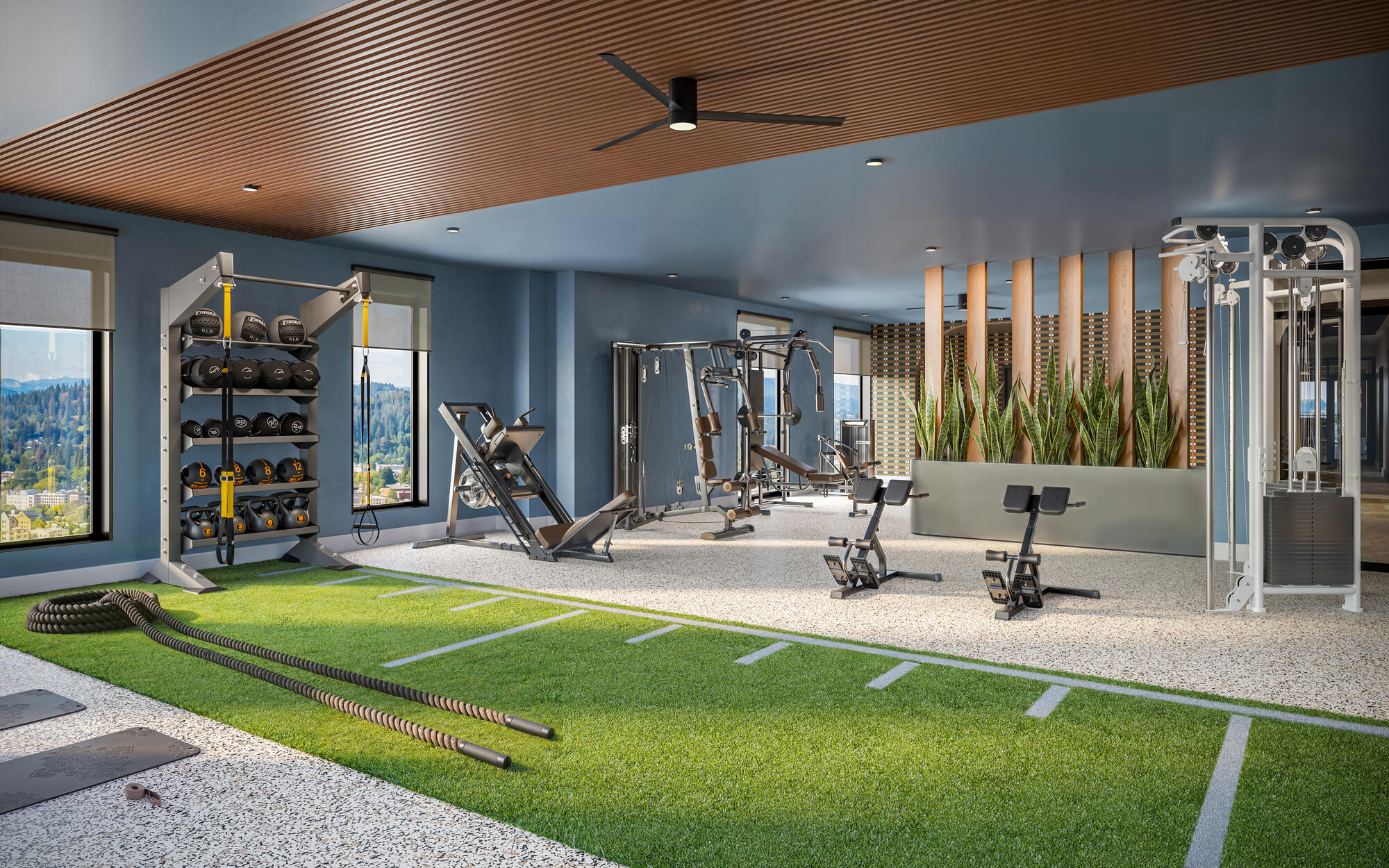Apartment fitness center with indoor turf area battle ropes and strength training equipment at Chapter Alder